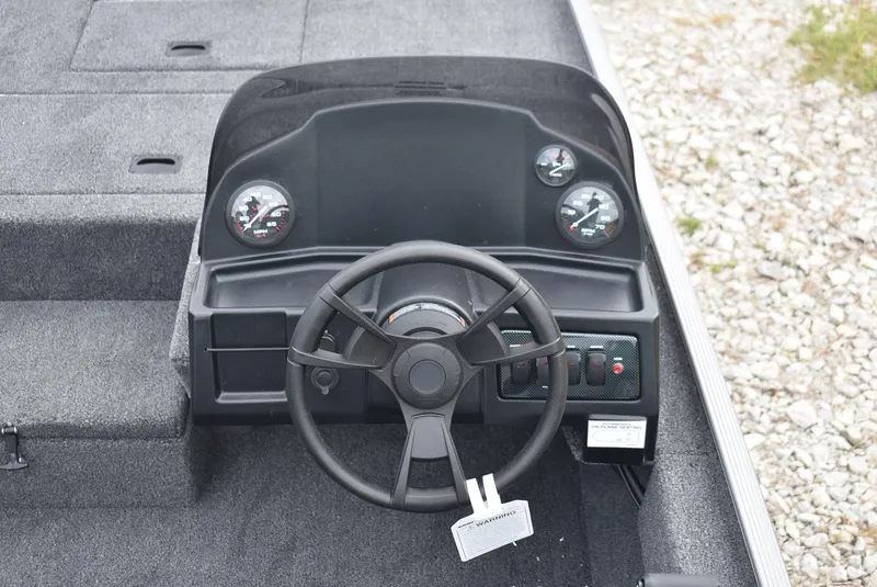 Slide: The Image of 2025 Lowe 16 Skorpion boat dashboard with steering wheel and gauges. - 9