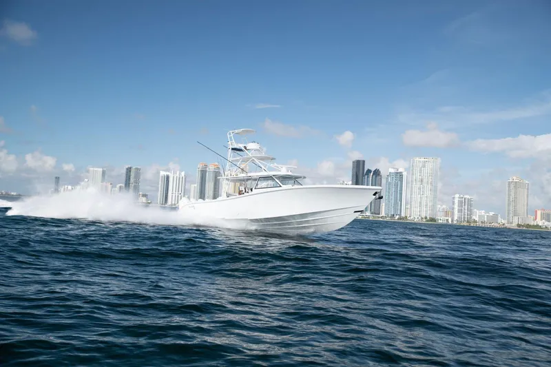 The Image of 2022 Yellowfin 54 Offshore boat cruising near city skyline on a sunny day. - 1
