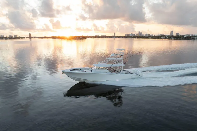 Slide: The Image of 2022 Yellowfin 54 Offshore boat cruising at sunset on calm waters. - 26