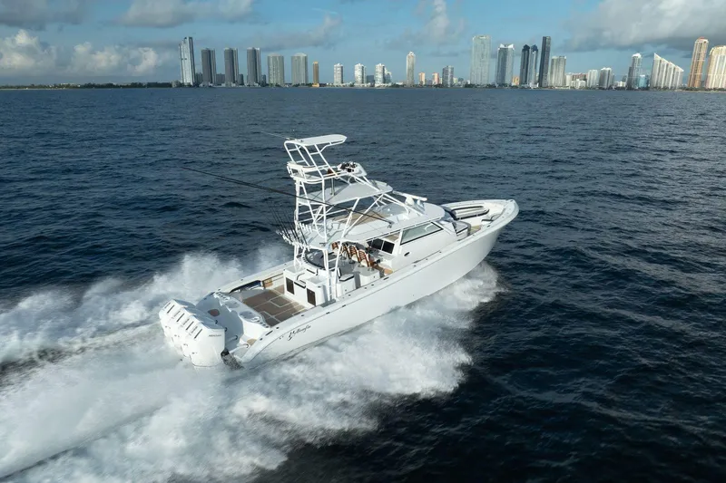 Slide: The Image of 2022 Yellowfin 54 Offshore boat cruising near city skyline. - 28