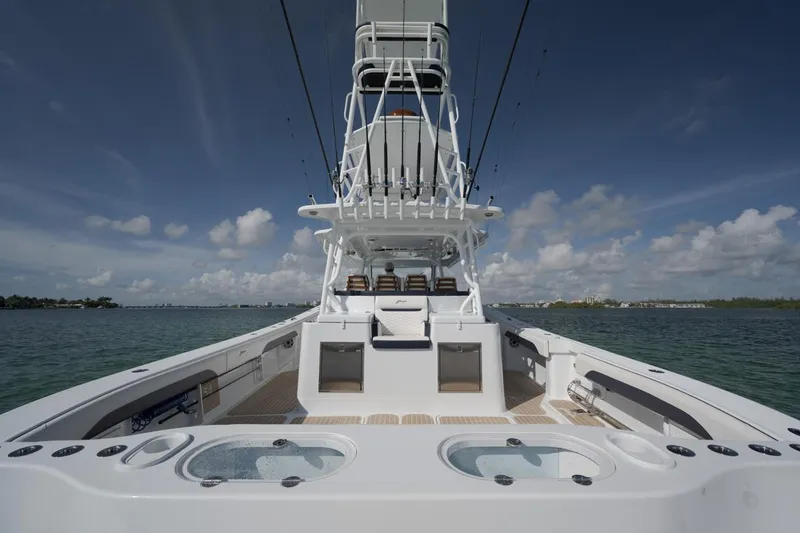 Slide: The Image of 2022 Yellowfin 54 Offshore boat on water, showcasing spacious deck and fishing amenities. - 6