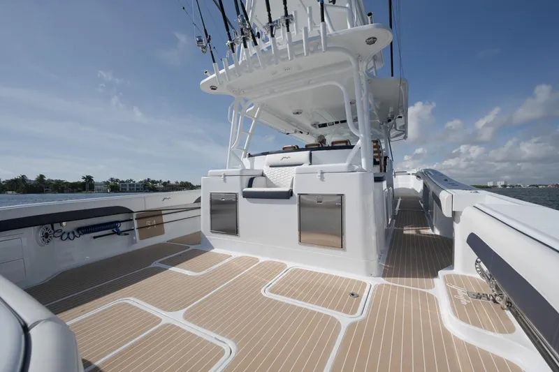 Slide: The Image of 2022 Yellowfin 54 Offshore boat deck with fishing rods and storage compartments. - 7
