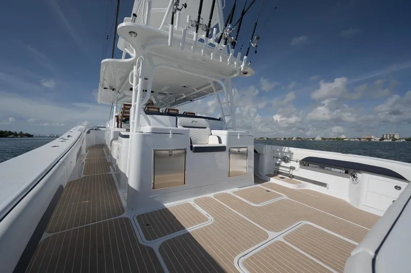 Slide: The Image of 2022 Yellowfin 54 Offshore boat with spacious deck and fishing equipment under clear skies. - 8