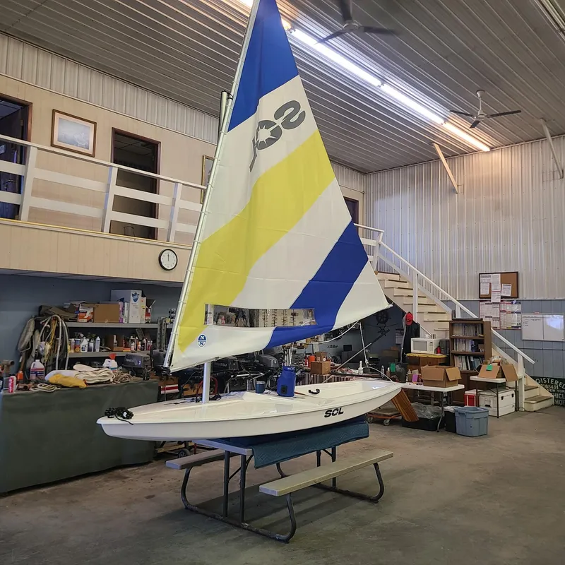 Slide: The Image of 2024 SERO Innovation SOL sailboat displayed indoors on a table. - 12