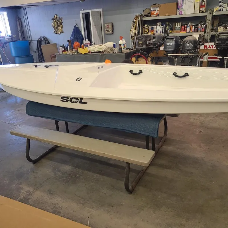 Slide: The Image of 2024 SERO Innovation SOL boat displayed indoors on a table in a workshop. - 7