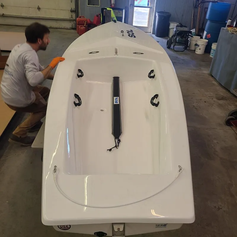 Slide: The Image of 2024 SERO Innovation SOL boat in workshop, man working nearby. - 8