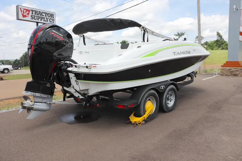 The Image of 2022 Tahoe 1950 boat on trailer, parked outdoors under a cloudy sky. - 0