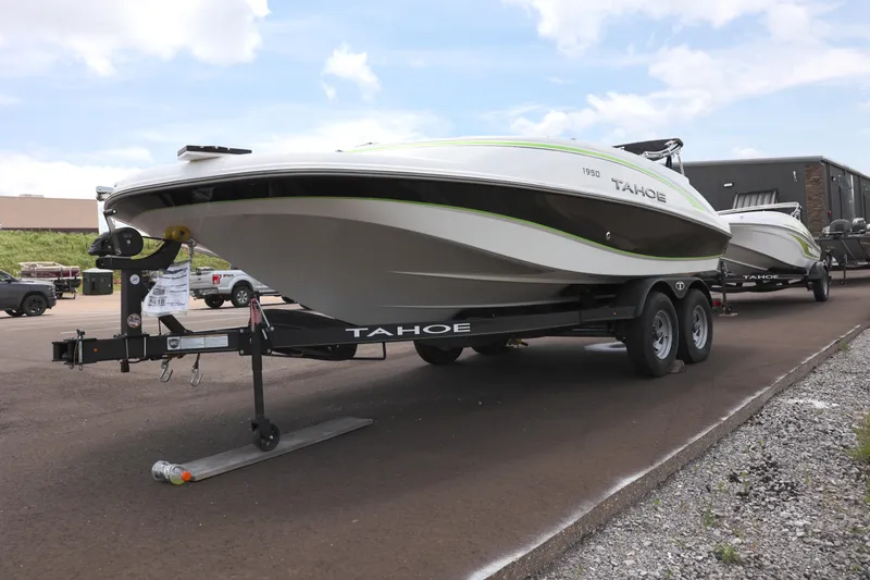 Slide: The Image of Tahoe 1950 boat on trailer, parked near Tractor Supply Co, 2022 model. - 1