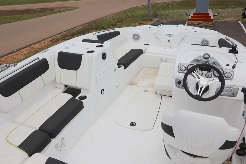 Slide: The Image of White Tahoe 1950 boat interior, 2022 model, featuring black cushioned seating and modern dashboard. - 10
