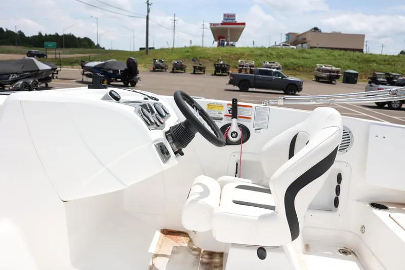 Slide: The Image of Interior of a 2022 Tahoe 1950 boat with steering wheel and control panel. - 6