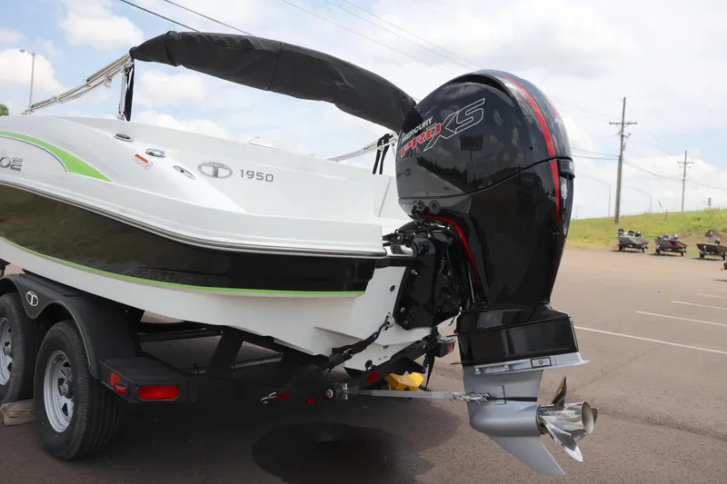 Slide: The Image of 2022 Tahoe 1950 boat with powerful outboard motor, parked on a trailer. - 8