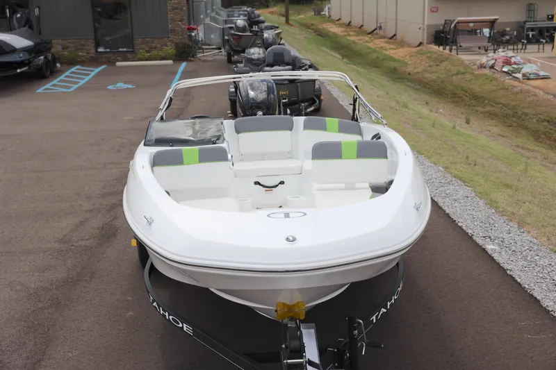 Slide: The Image of Tahoe 1950 boat, 2022 model, parked on a trailer in a dealership lot. - 9
