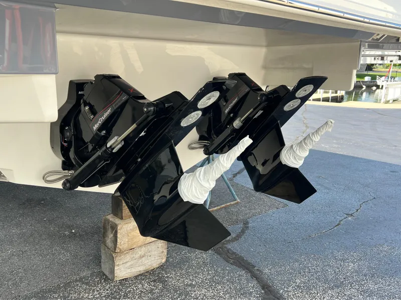 Slide: The Image of 2025 Sea Ray Sundancer 320 outdrives on display, supported by wooden blocks. - 12