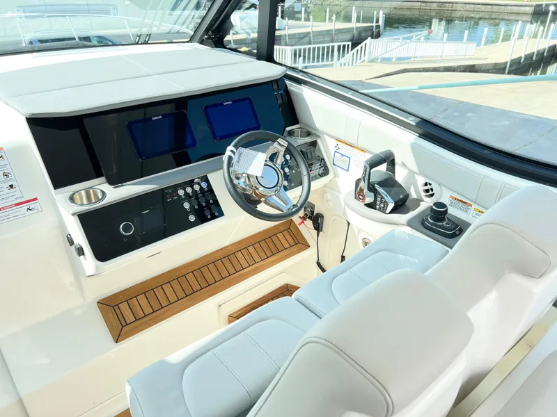 Slide: The Image of 2025 Sea Ray Sundancer 320 helm with modern controls and sleek design. - 4
