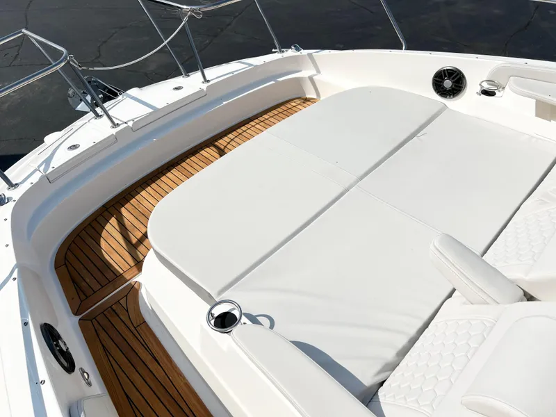 Slide: The Image of 2025 Sea Ray Sundancer 320 deck with white seating and teak flooring. - 8