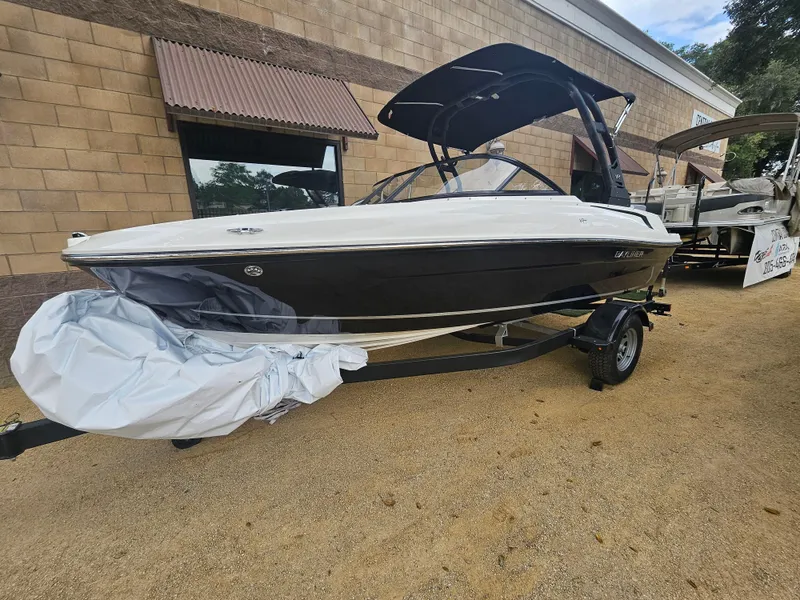 Slide: The Image of 2024 Bayliner DX2000 boat on trailer, parked outdoors near a building. - 10