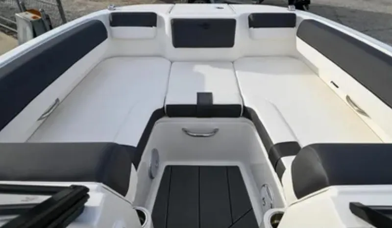 Slide: The Image of 2024 Bayliner DX2000 boat interior with cushioned seating and sleek design. - 4