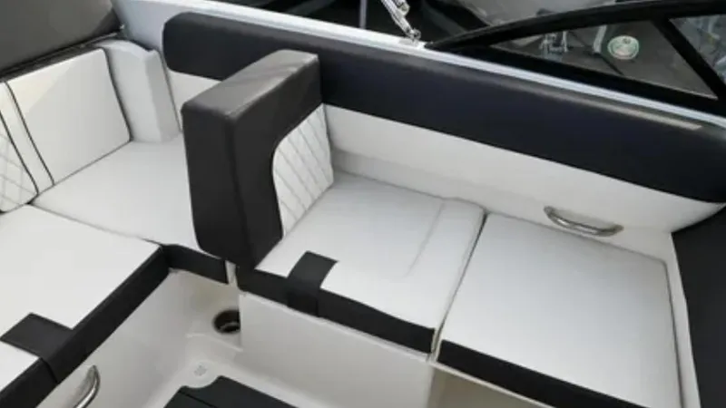 Slide: The Image of 2024 Bayliner DX2000 boat interior with sleek black and white seating design. - 5