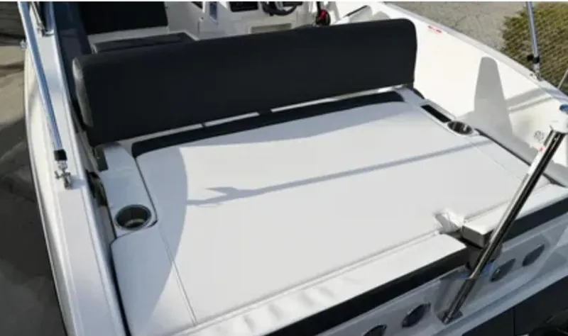 Slide: The Image of 2024 Bayliner DX2000 boat interior with cushioned seating and cup holders. - 6
