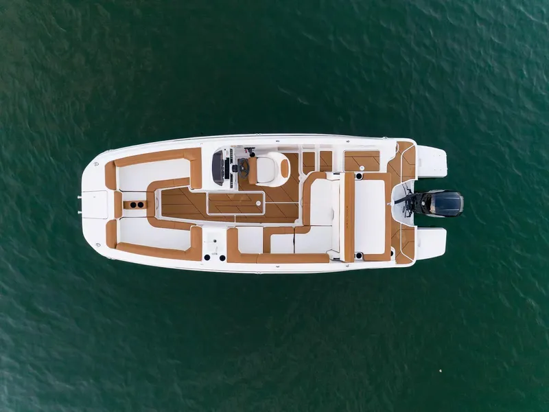 Slide: The Image of 2024 Bayliner DX2000 boat, aerial view, showcasing spacious deck layout on water. - 8