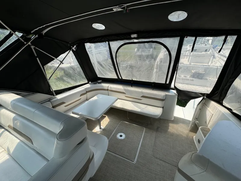 Slide: The Image of 1999 Formula 41 Performance Cruiser interior with seating and table, under a black canopy. - 12