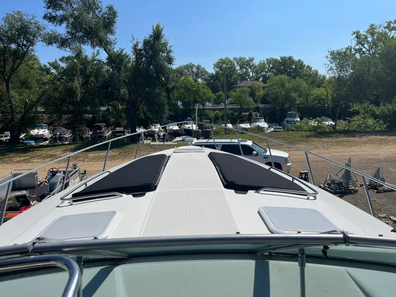 Slide: The Image of 1999 Formula 41 Performance Cruiser on land, surrounded by trees and parked vehicles. - 2