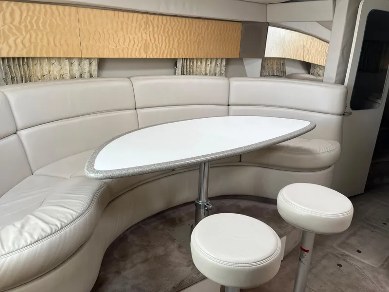 Slide: The Image of 1999 Formula 41 Performance Cruiser interior with curved seating and table. - 23