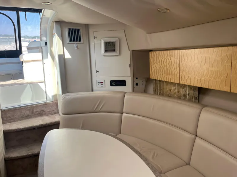 Slide: The Image of 1999 Formula 41 Performance Cruiser interior with beige seating and wooden cabinets. - 24