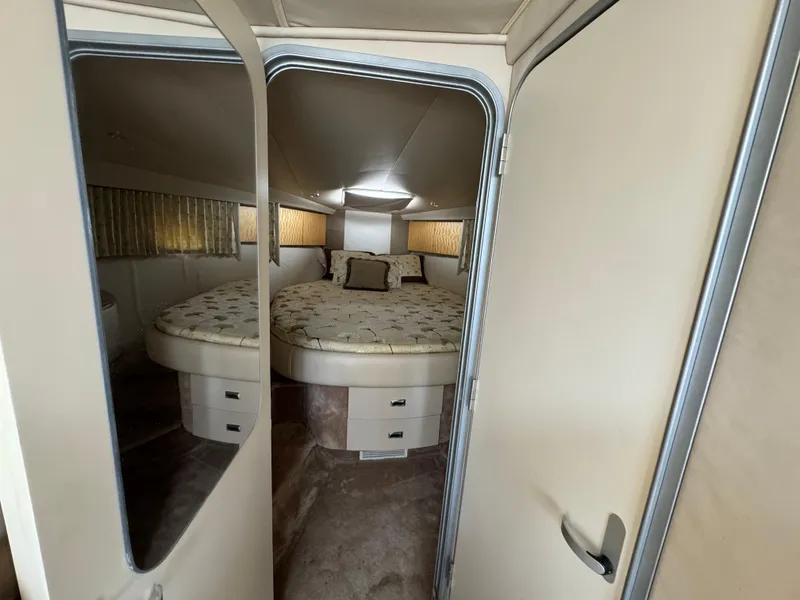 Slide: The Image of 1999 Formula 41 Performance Cruiser cabin with cozy bed and mirrored door. - 25