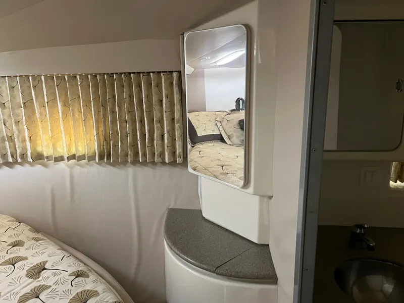 Slide: The Image of 1999 Formula 41 Performance Cruiser interior with bed, mirror, and patterned curtains. - 29