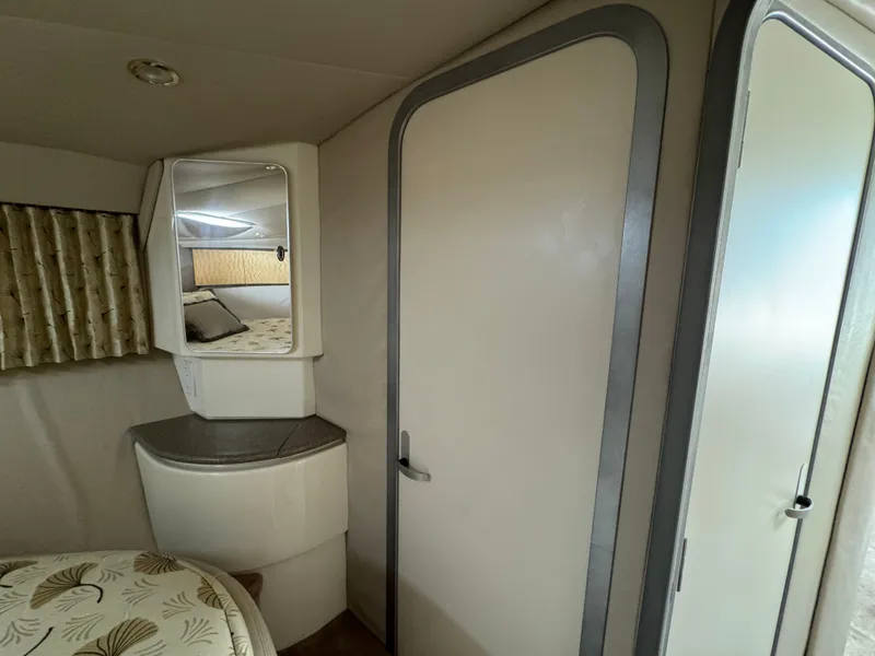 Slide: The Image of 1999 Formula 41 Performance Cruiser interior with mirror, bed, and modern design elements. - 30