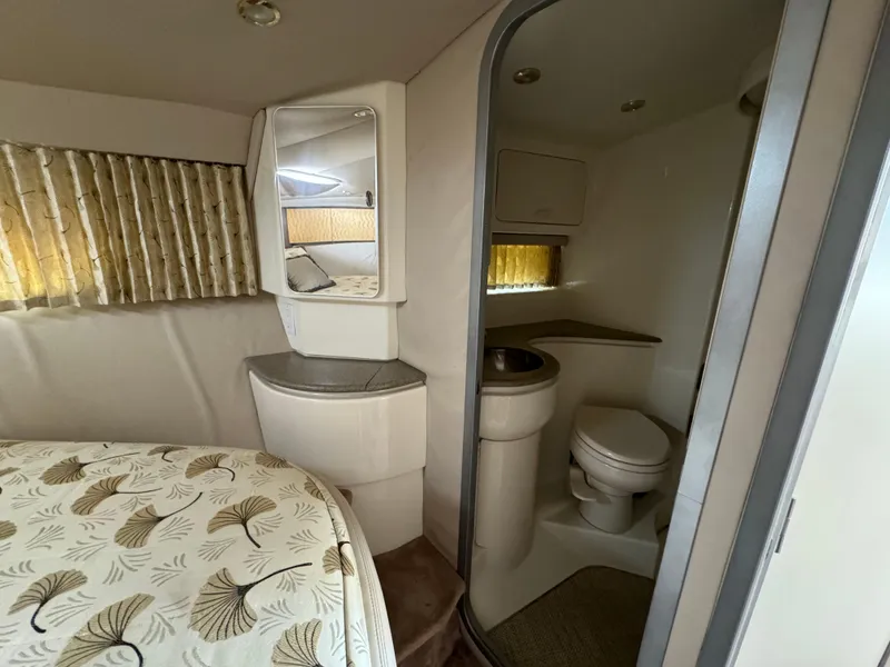 Slide: The Image of 1999 Formula 41 Performance Cruiser interior with bed, mirror, and compact bathroom. - 31