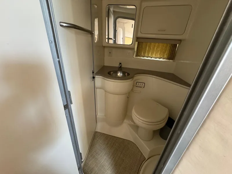 Slide: The Image of 1999 Formula 41 Performance Cruiser bathroom with sink, toilet, and mirror. - 32