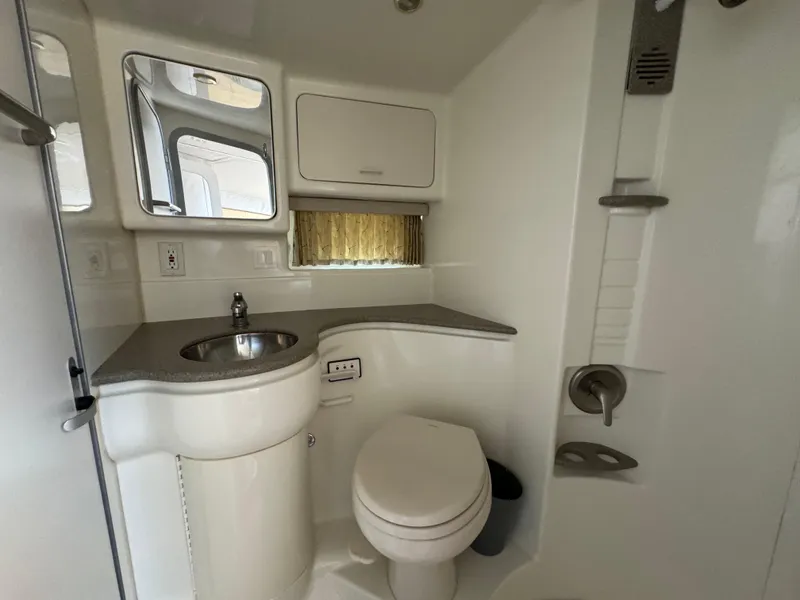 Slide: The Image of 1999 Formula 41 Performance Cruiser bathroom with sink, toilet, and shower. - 33