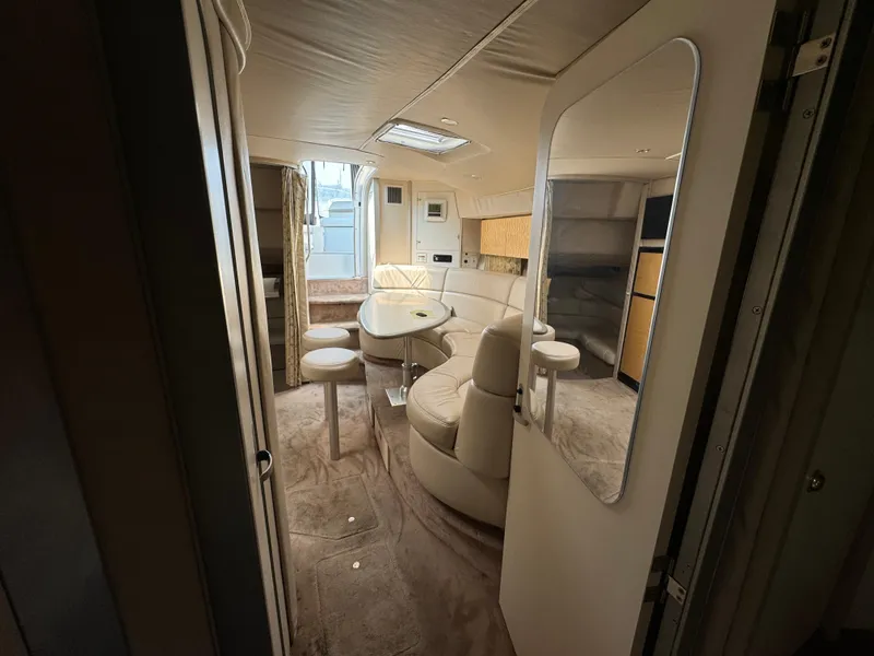Slide: The Image of 1999 Formula 41 Performance Cruiser interior with beige seating and dining area. - 36