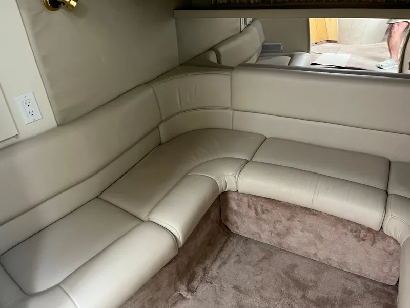 Slide: The Image of 1999 Formula 41 Performance Cruiser interior with beige leather seating and carpeted flooring. - 37