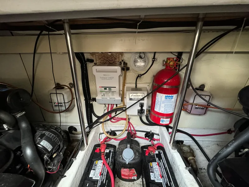 Slide: The Image of Engine compartment of a 1999 Formula 41 Performance Cruiser with batteries and fire extinguisher. - 41