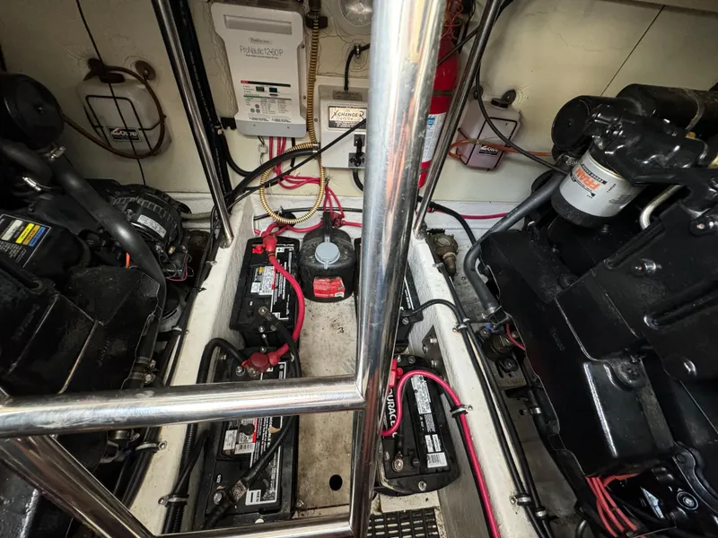 Slide: The Image of Engine room of a 1999 Formula 41 Performance Cruiser with visible batteries and wiring. - 42