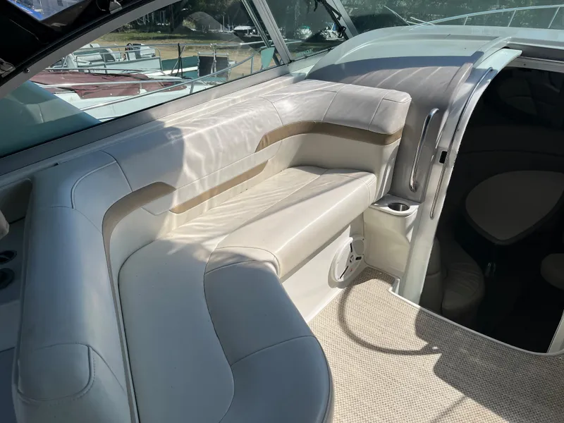 Slide: The Image of 1999 Formula 41 Performance Cruiser interior with white leather seating and carpeted flooring. - 5