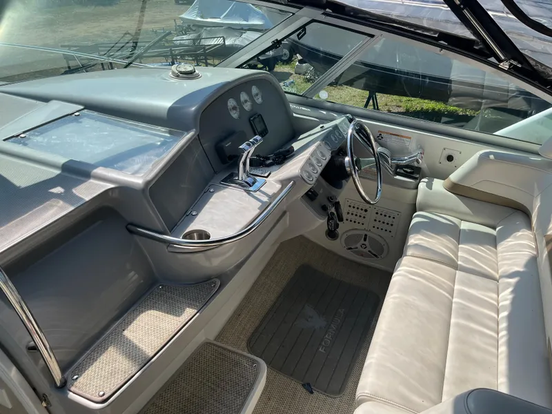 Slide: The Image of 1999 Formula 41 Performance Cruiser cockpit with steering wheel, controls, and seating. - 8