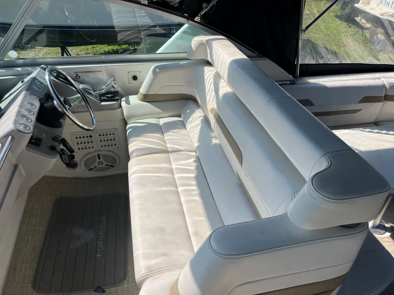 Slide: The Image of 1999 Formula 41 Performance Cruiser interior with white seating and steering wheel. - 9