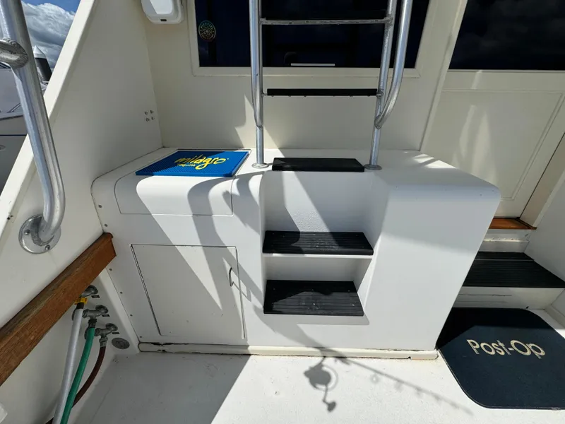 Slide: The Image of 1990 Post 44 Sport Fisherman boat interior with steps and storage compartment. - 10