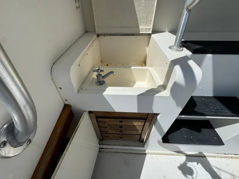 Slide: The Image of 1990 Post 44 Sport Fisherman boat sink and storage area. - 11