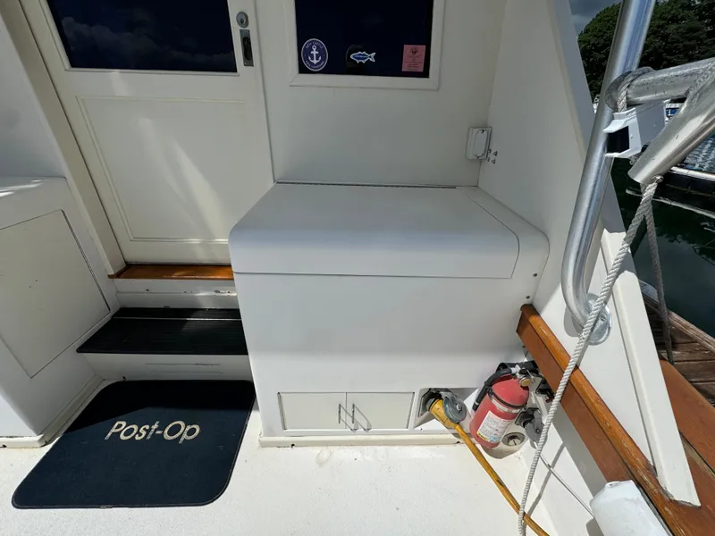 Slide: The Image of 1990 Post 44 Sport Fisherman boat interior with steps, mat, and fire extinguisher. - 12