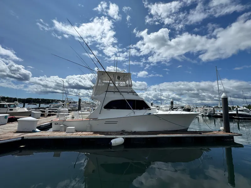 Slide: The Image of 1990 Post 44 Sport Fisherman yacht docked at marina under blue sky. - 2