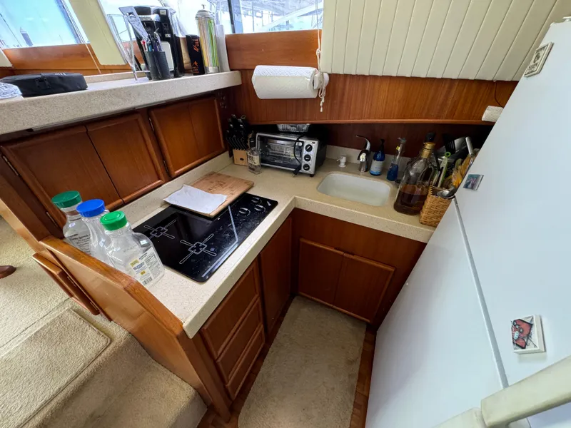 Slide: The Image of Compact kitchen in 1990 Post 44 Sport Fisherman yacht with stove, sink, and appliances. - 20