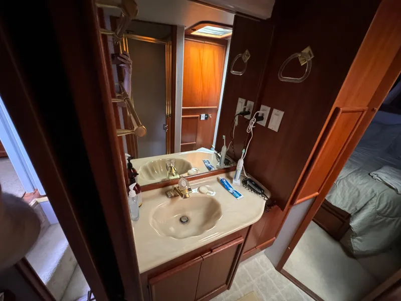 Slide: The Image of Bathroom vanity in 1990 Post 44 Sport Fisherman yacht, featuring sink and mirror. - 23