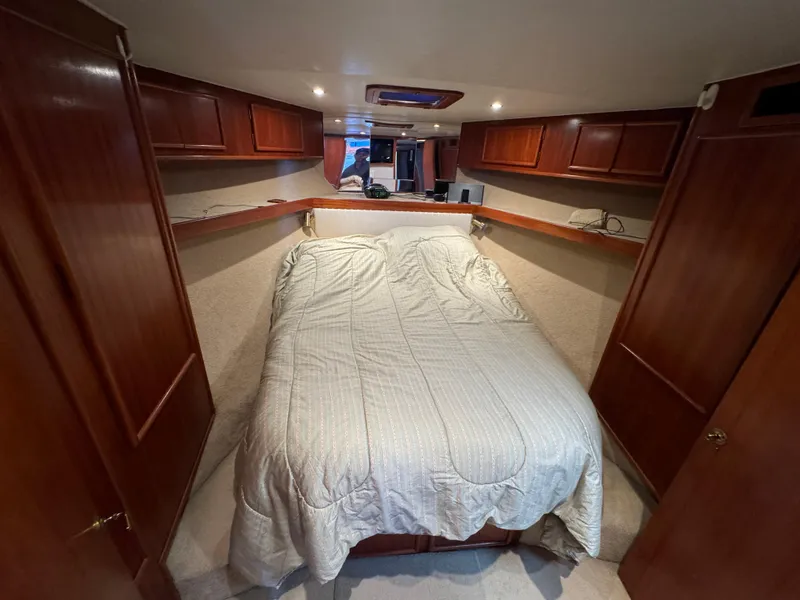 Slide: The Image of Cozy cabin interior of 1990 Post 44 Sport Fisherman with wood cabinets and bed. - 26