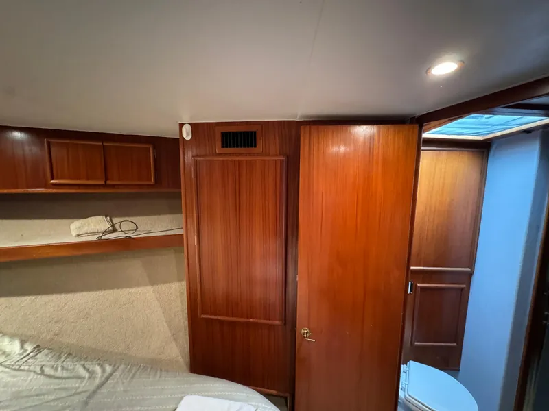 Slide: The Image of Interior of 1990 Post 44 Sport Fisherman yacht with wooden cabinetry and cozy lighting. - 28