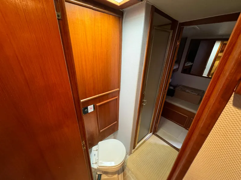 Slide: The Image of 1990 Post 44 Sport Fisherman yacht interior with wooden cabinetry and compact bathroom. - 29